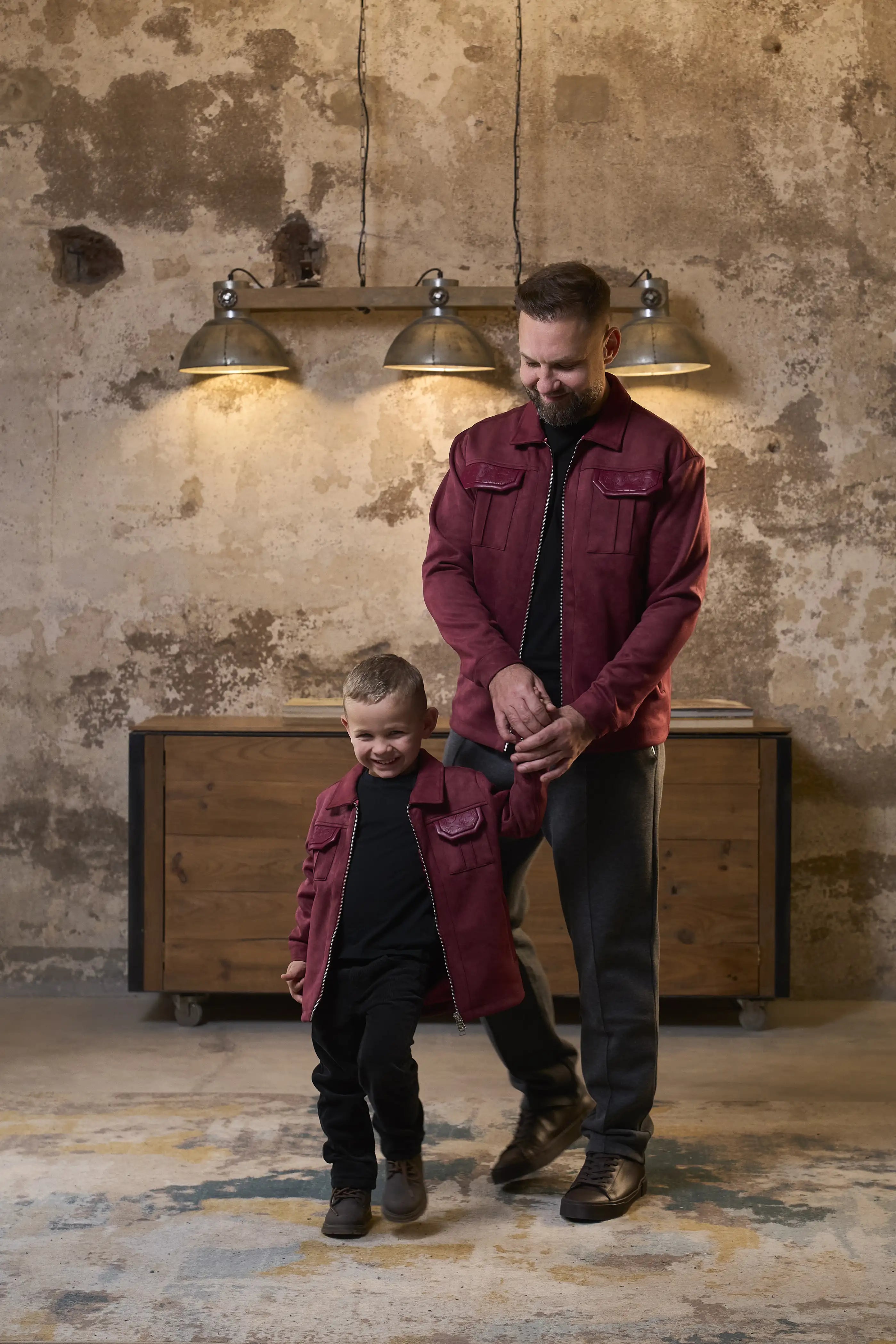 Father and son in matching ROMIMI jacket