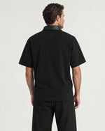 Man wearing the Romimi Adam Braided Collar Polo - Black, back view