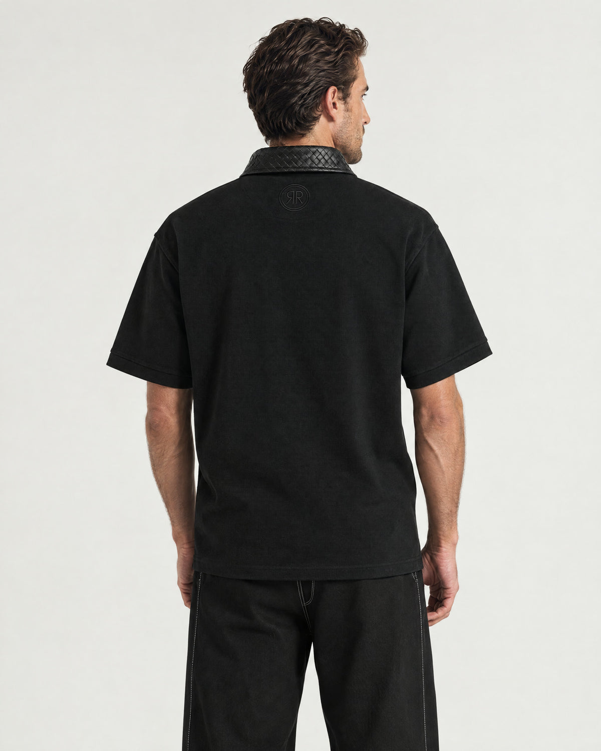 Man wearing the Romimi Adam Braided Collar Polo - Black, back view