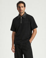 Man wearing the Romimi Adam Braided Collar Polo - Black, front view