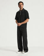 Man wearing the Romimi Adam Braided Collar Polo - Black, full length