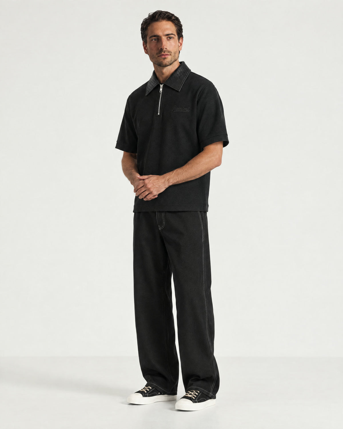 Man wearing the Romimi Adam Braided Collar Polo - Black, full length