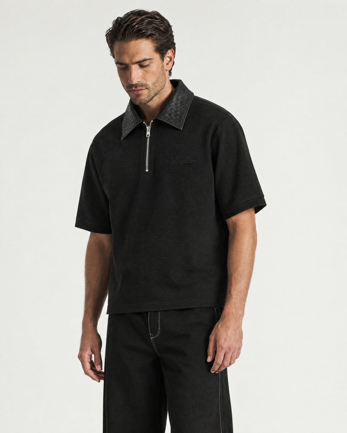 Man wearing the Romimi Adam Braided Collar Polo - Black, three-quarter view