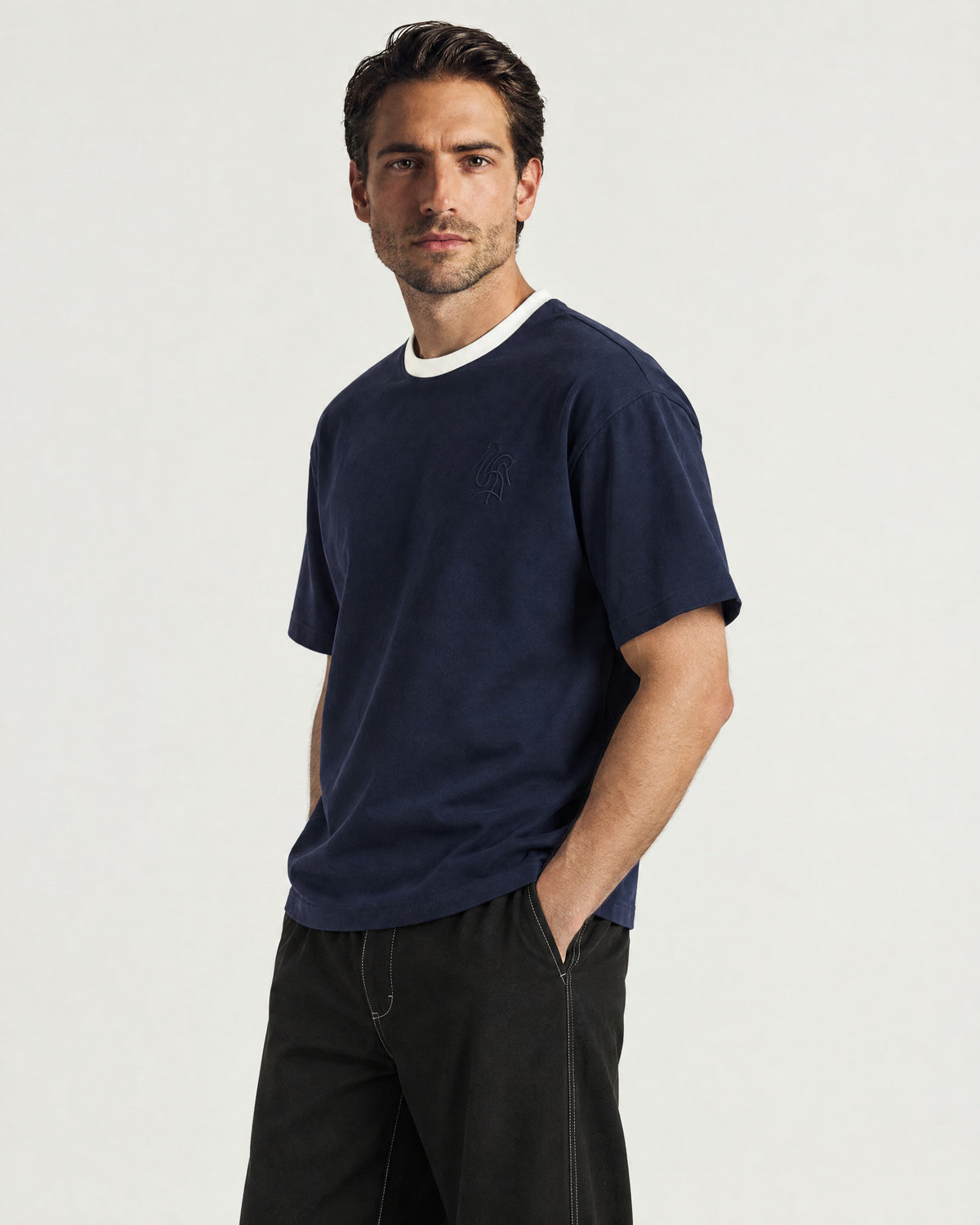 Man wearing the Romimi Alex Contrast Collar Tee, three-quarter view