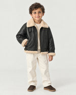 Boy wearing the Romimi kids aviator jacket in black with a cream collar, front view
