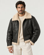 Man wearing the Romimi aviator jacket in black with a cream collar, front view