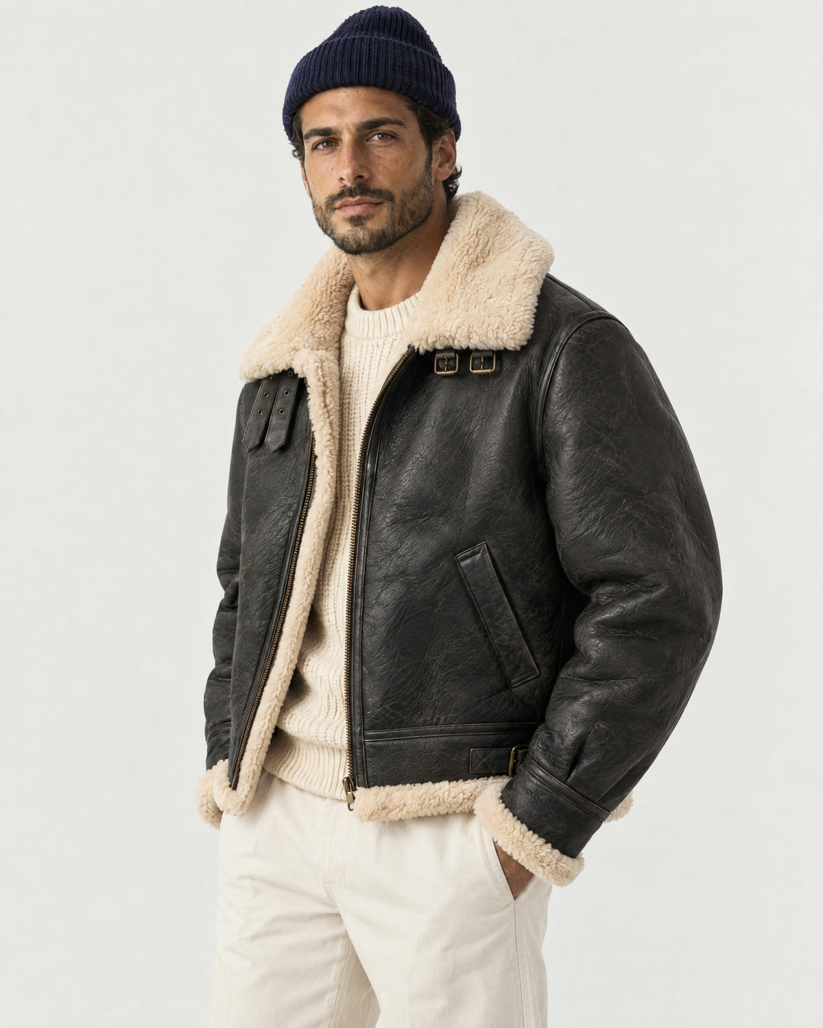 Man wearing the Romimi aviator jacket in black with a cream collar, three-quarter view