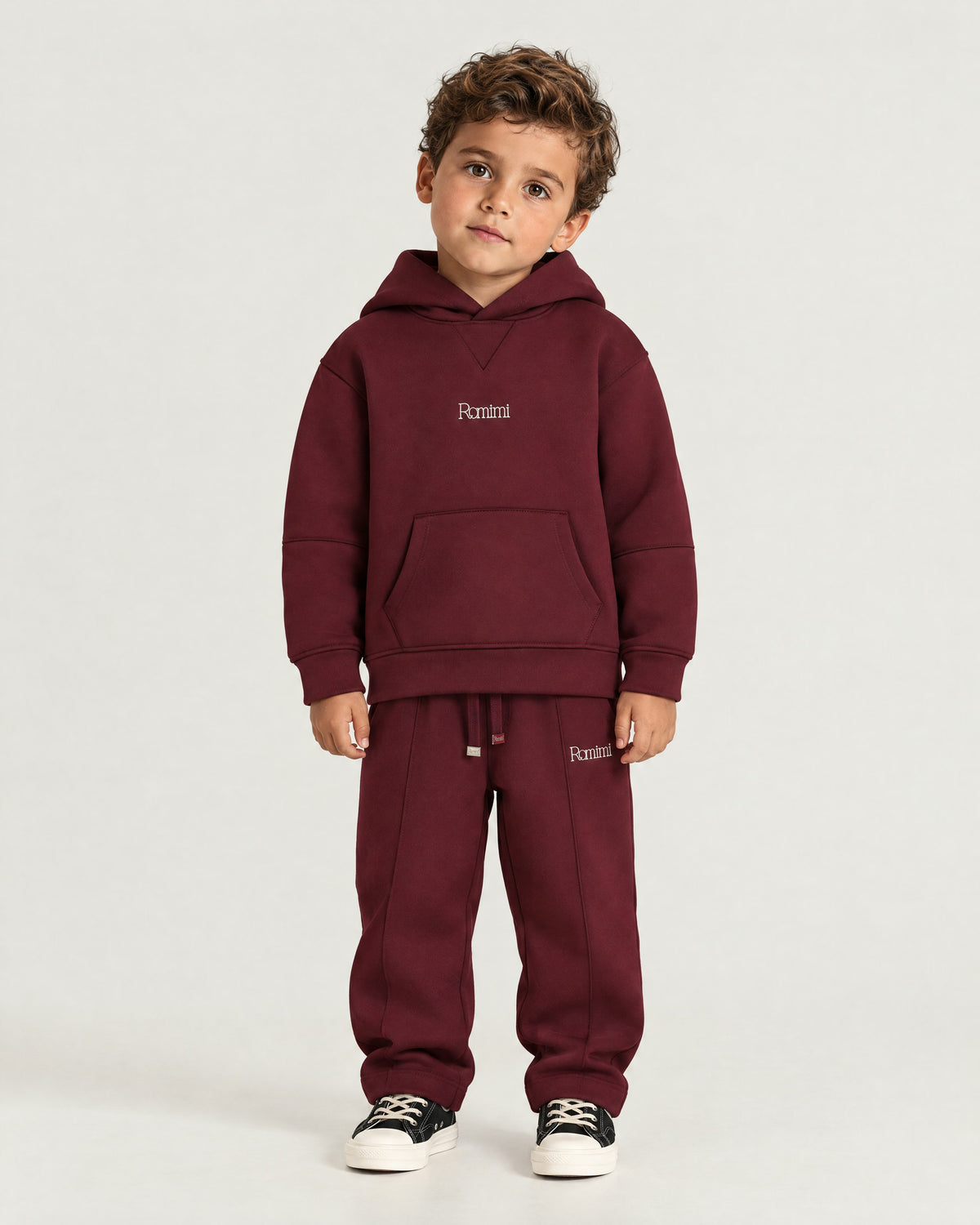 Little boy wearing the Romimi Bond Signature Hoodie, front view