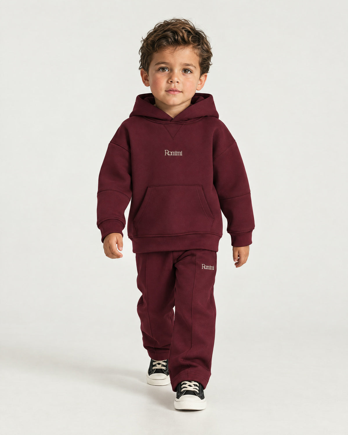 Little boy wearing the Romimi Bond Signature Hoodie, full length