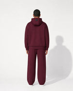Romimi Bond Signature Hoodie in burgundy, worn by a man, back view