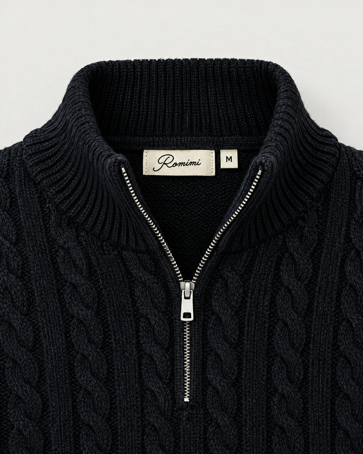 Romimi Cable Knit Quarter-Zip in Black, label close-up