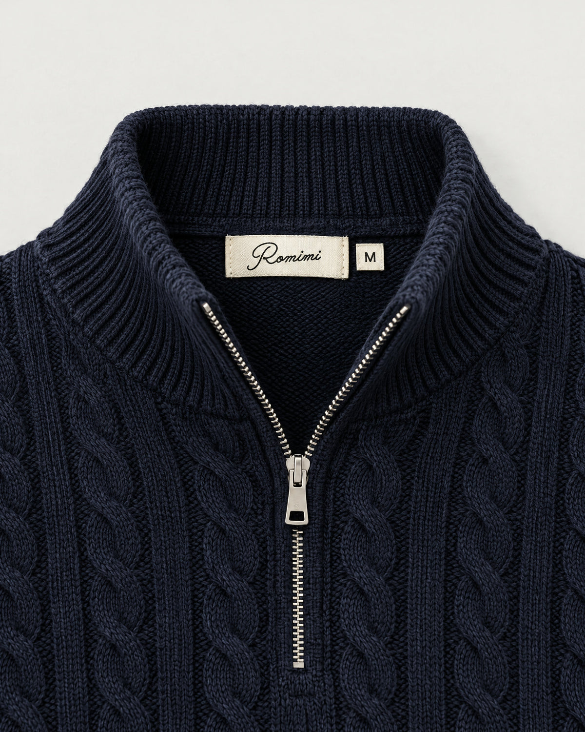 Romimi Cable Knit Quarter-Zip in Navy, label close-up