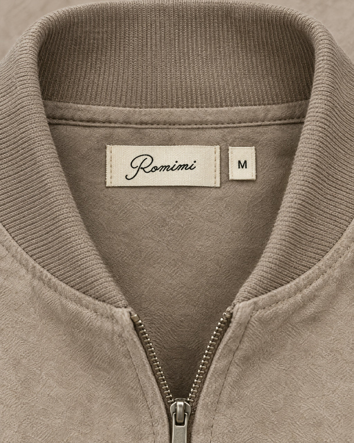 Romimi Faux Suede Bomber in Taupe, label close-up