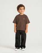 Little boy wearing the Romimi Graphic Tee - Chocolat, full length