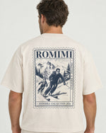 Detail of the Romimi graphic tee in cream with the Andorra ski print: the Andorra ski stamp print on the back, a father and son skiing