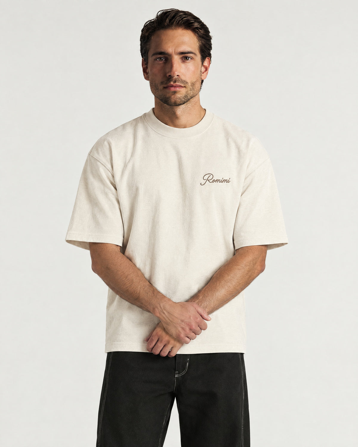 Man wearing the Romimi Graphic Tee - Beige, front view