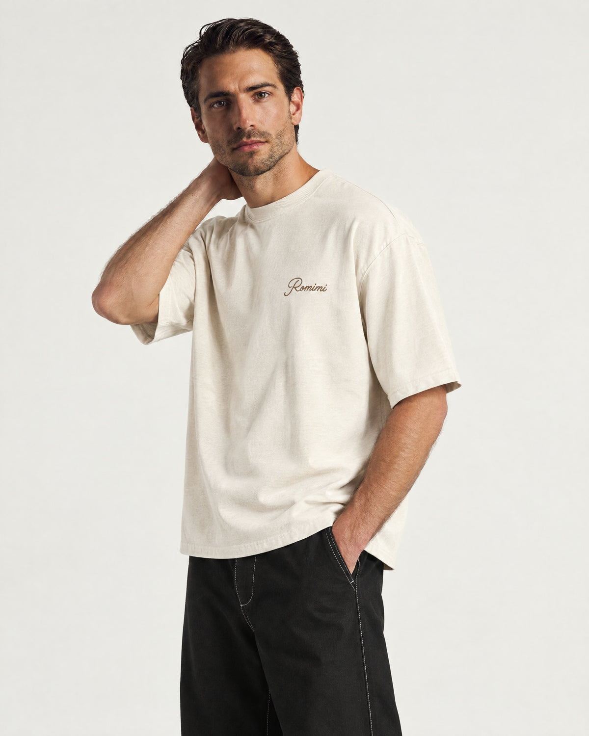 Man wearing the Romimi Graphic Tee - Beige, three-quarter view