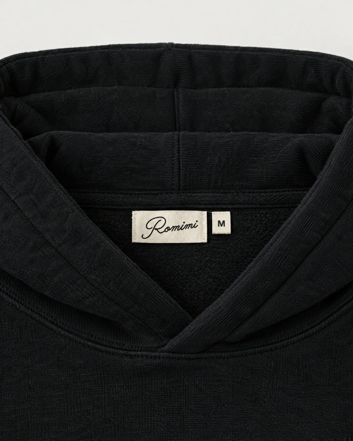 Romimi Heavyweight Hoodie in Black, label close-up