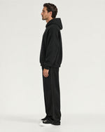 Romimi Heavyweight Hoodie in Black, side view, worn