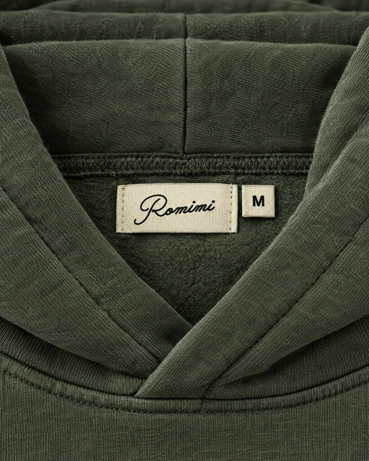 Romimi Heavyweight Hoodie in Olive, label close-up