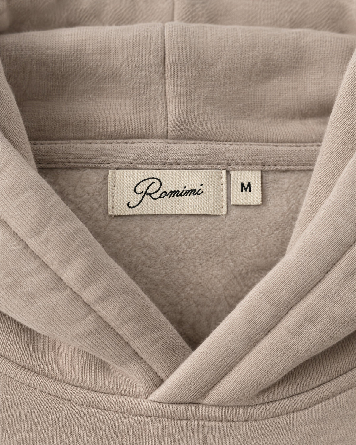 Romimi Heavyweight Hoodie in Sand, label close-up