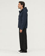 Romimi Hooded Tech Jacket in Navy, side view, worn