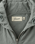 Romimi Hooded Tech Jacket in Sage Grey, label close-up
