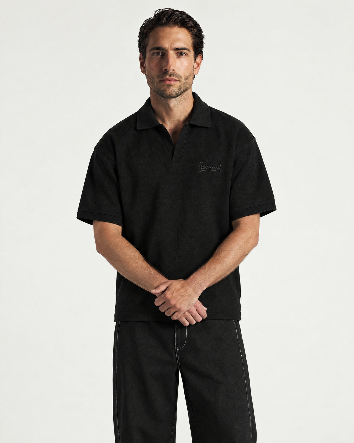 Man wearing the Romimi Laurent Classic Ribbed Polo, front view