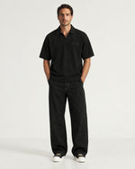 Man wearing the Romimi Laurent Classic Ribbed Polo, full length