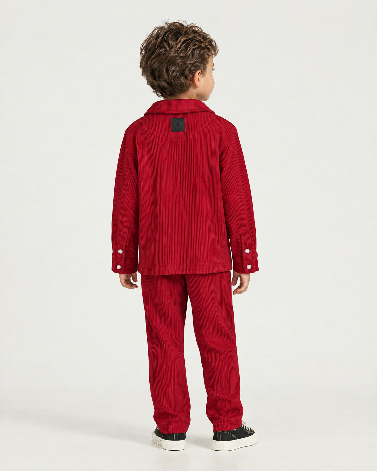 Little boy wearing the Romimi Pleat Shirt, back view