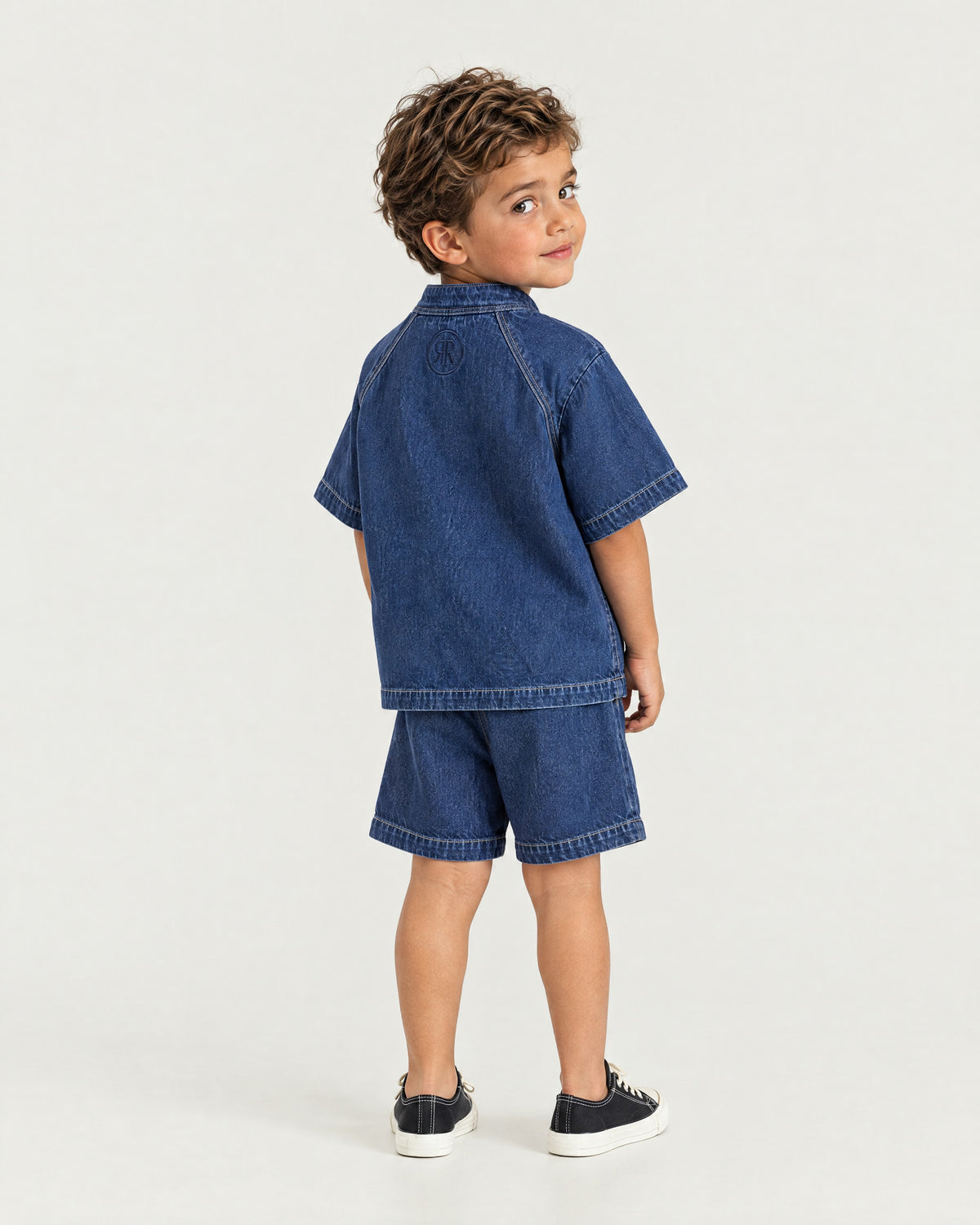 Little boy wearing the Romimi Léon Denim Shirt, back view