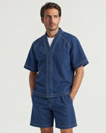 Man wearing the Romimi Léon Denim Shirt, three-quarter view