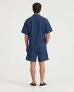 Man wearing the Romimi Léon Denim Short, back view