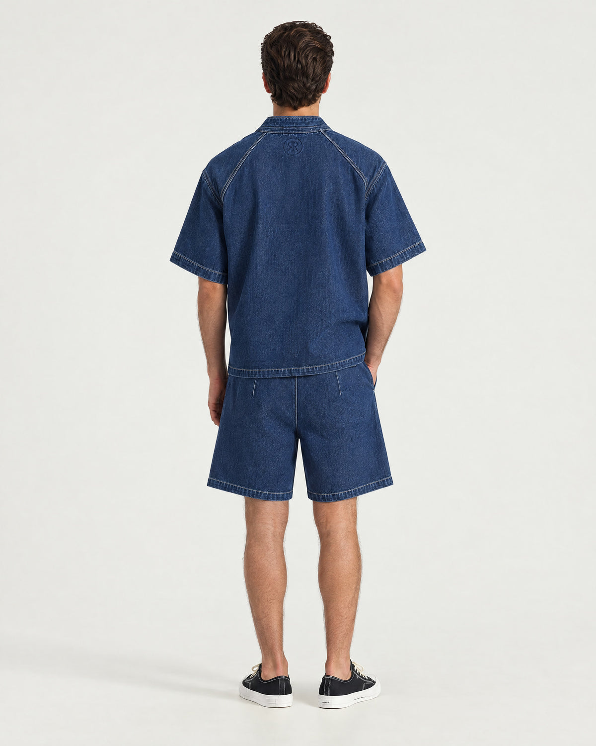 Man wearing the Romimi Léon Denim Short, back view