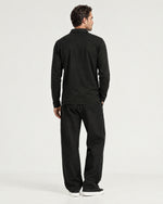 Romimi Mercerized Long Sleeve Polo in Black, back view, worn