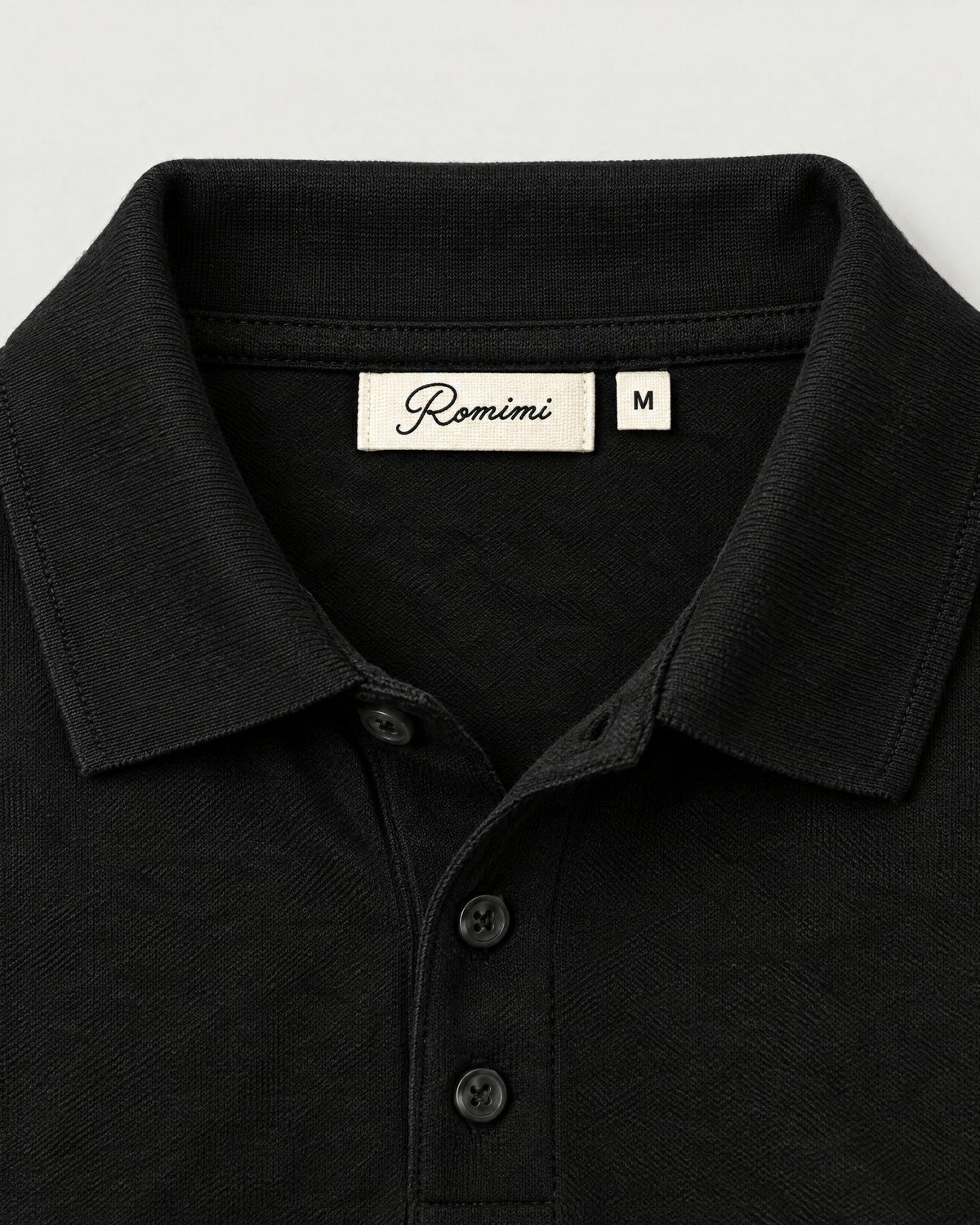 Romimi Mercerized Long Sleeve Polo in Black, label close-up