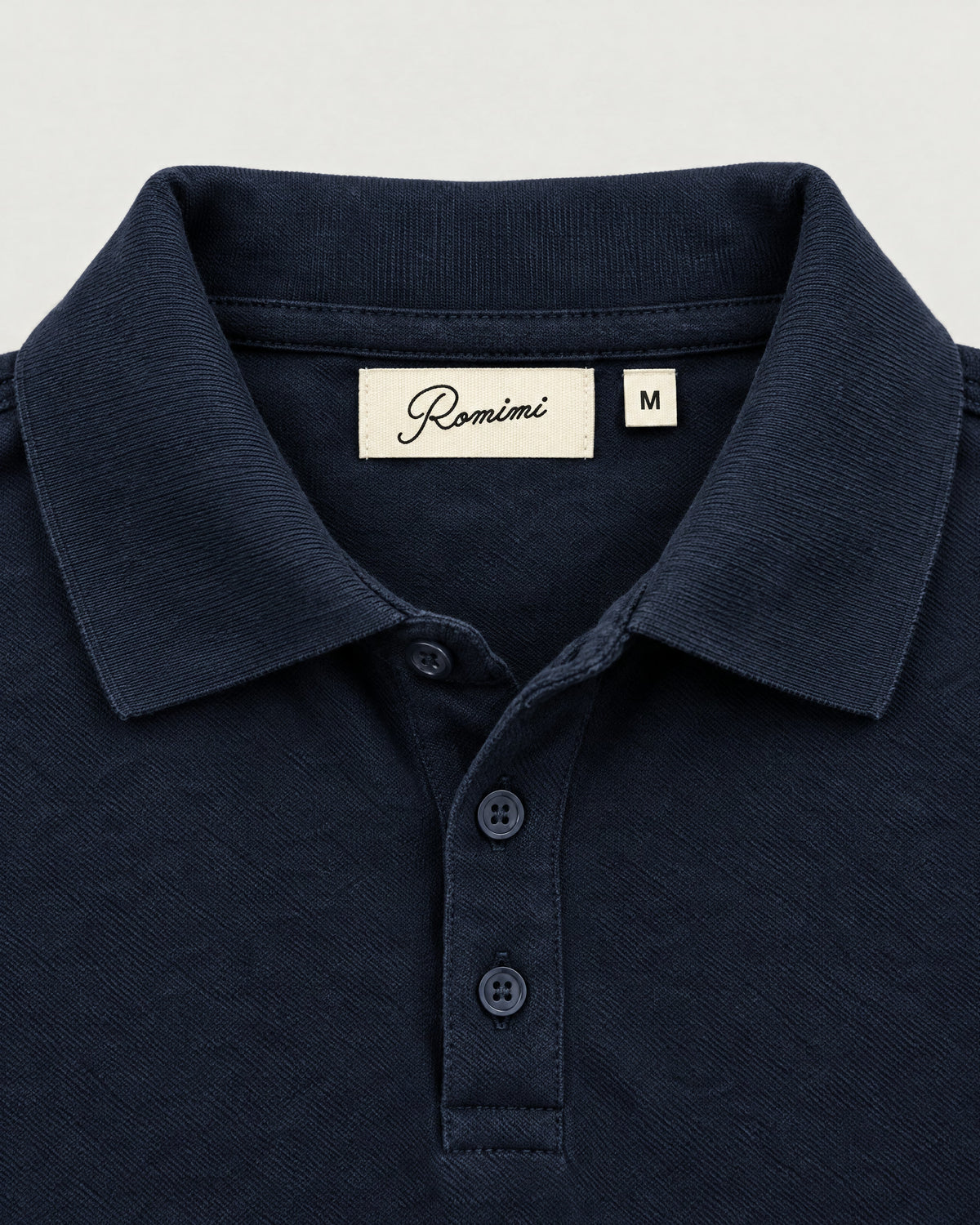Romimi Mercerized Long Sleeve Polo in Navy, label close-up