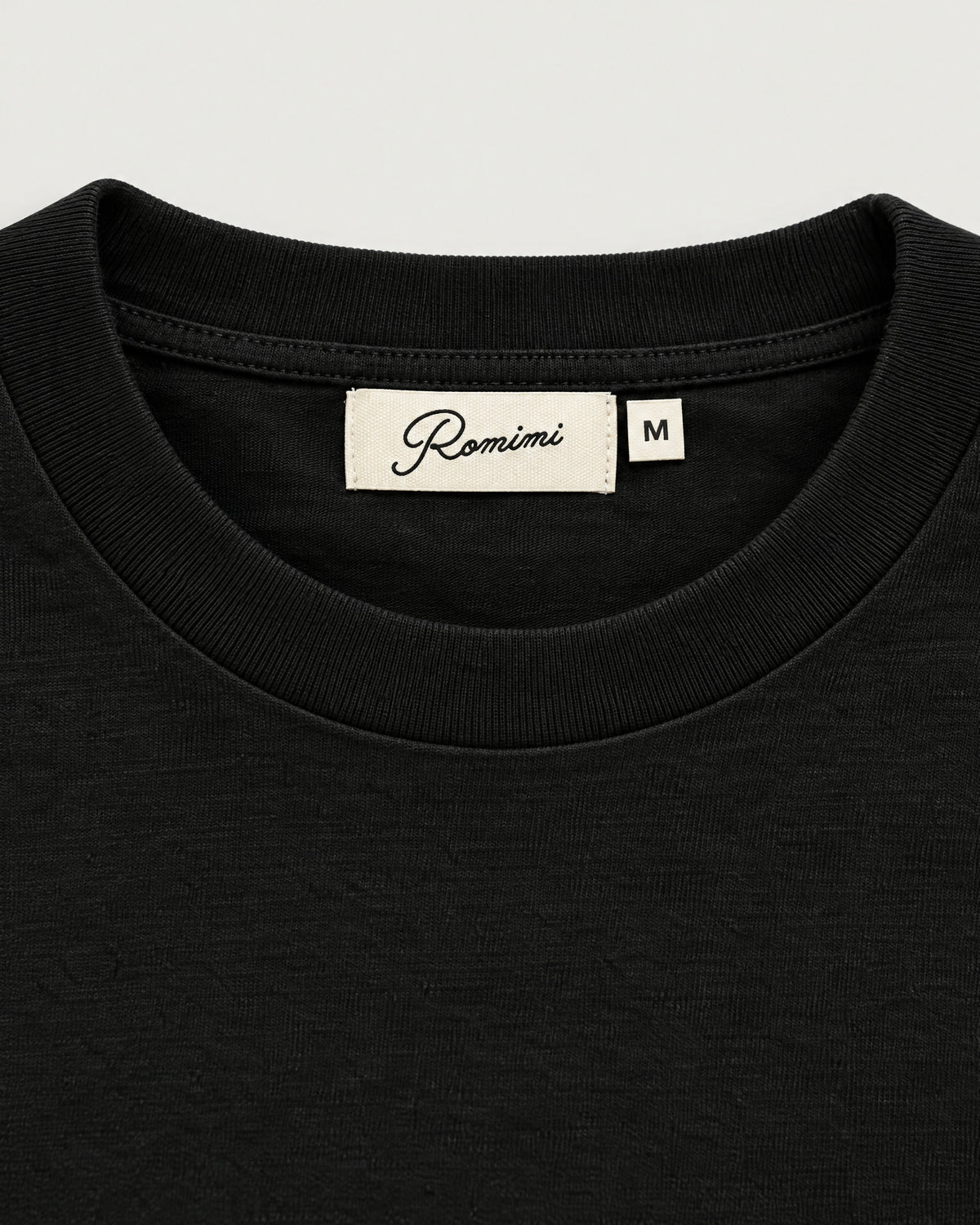 Romimi Mercerized Long Sleeve Tee in Black, label close-up