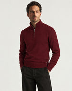 Man wearing the Romimi Merino Heritage Quarter-Zip, three-quarter view
