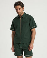 Man wearing the Romimi Paul Camp Collar Zip Shirt, three-quarter view