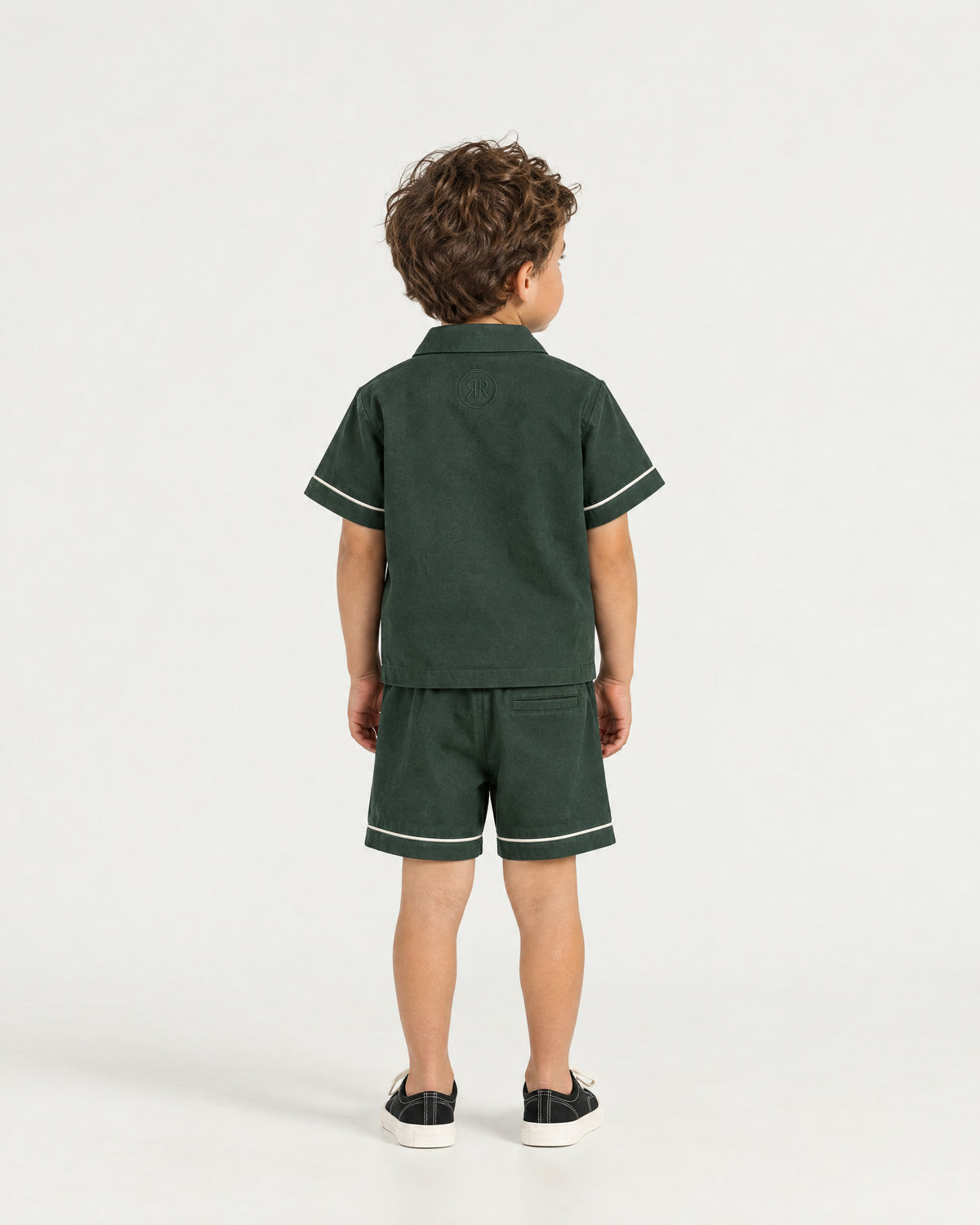 Little boy wearing the Romimi Paul Drawcord Shorts, back view