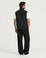 Romimi Reversible Windbreaker Gilet in Black, back view, worn