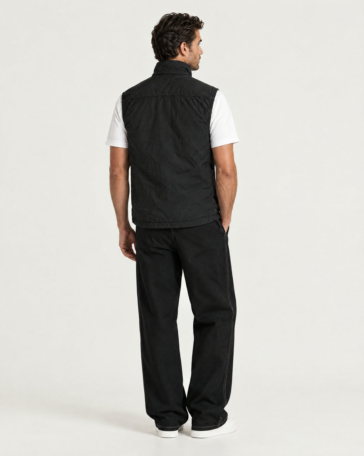 Romimi Reversible Windbreaker Gilet in Black, back view, worn