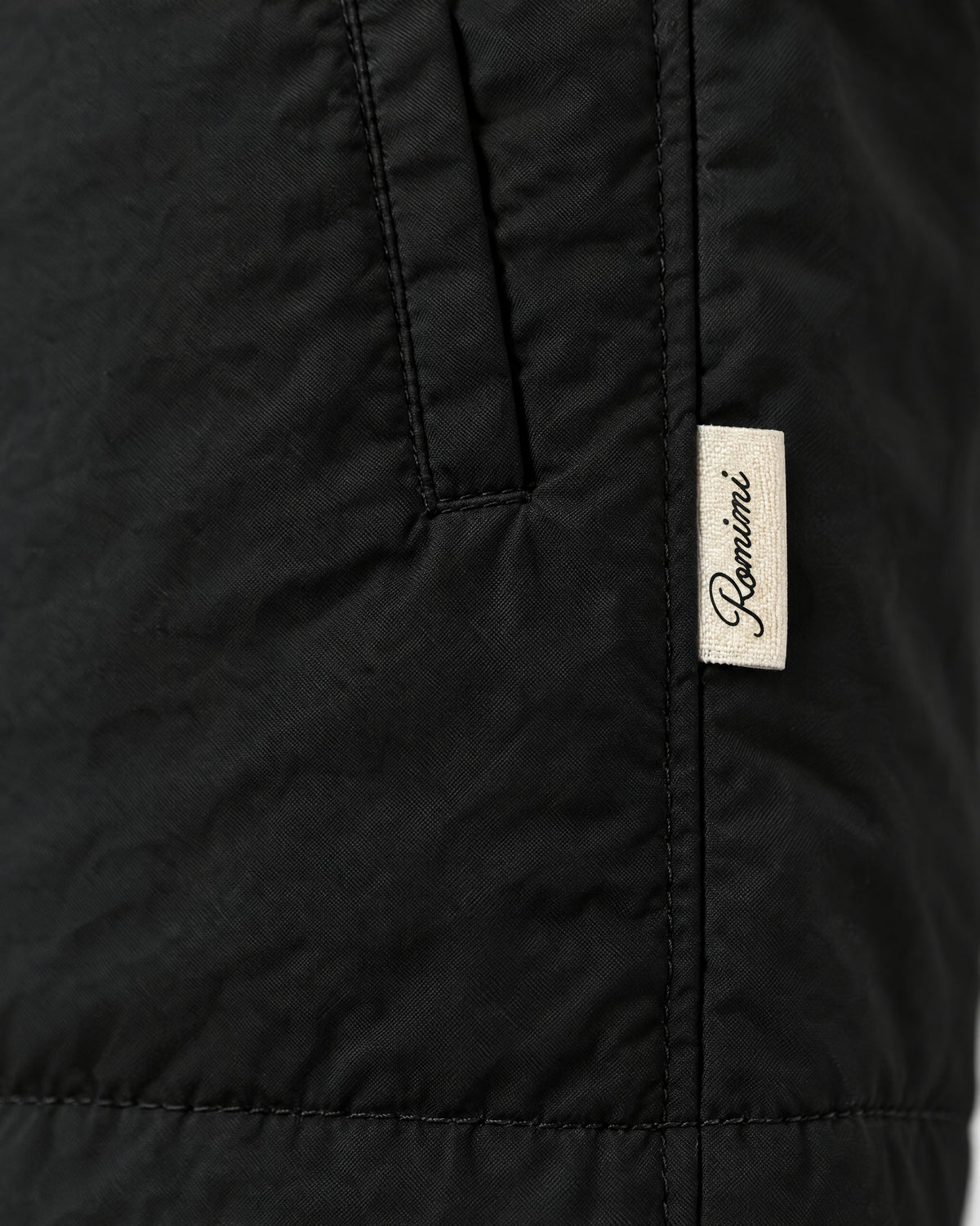 Romimi Reversible Windbreaker Gilet in Black, label close-up