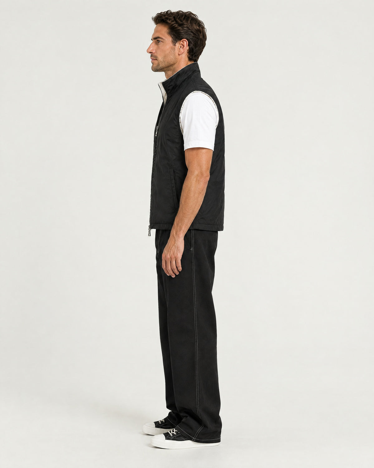 Romimi Reversible Windbreaker Gilet in Black, side view, worn