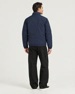 Romimi Reverso Jacket in Navy, back view, worn