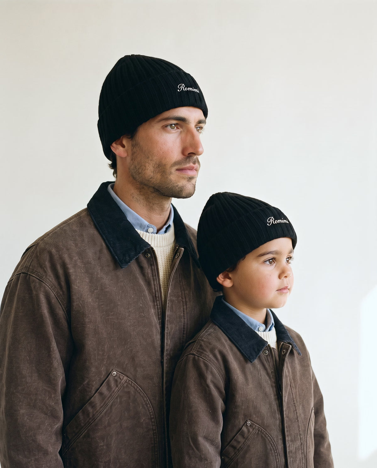 Father and son wearing the Romimi rib-knit beanie in black