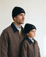 Father and son wearing the Romimi rib-knit beanie in black