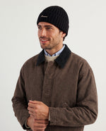 Man wearing the rib-knit beanie in black