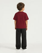 Little boy wearing the Romimi Signature Crest Tee, back view